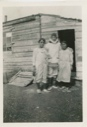 Image of F. Alliger visiting two Eskimo [Inuit] women in front of their house